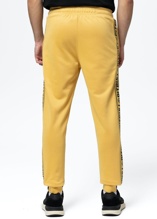Spodnie dresowe PIT BULL OLDSCHOOL TAPE LOGO TERRY pale yellow